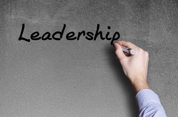 hand writing a leadership word