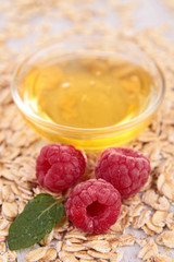 closeup on bowl of honey and raspberry