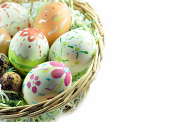 Colorful painted easter eggs in brown basket