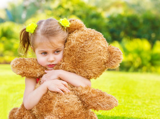 Sad girl with teddy bear