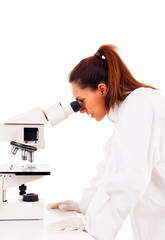 Young female researcher looking into a microscope, isolated on w