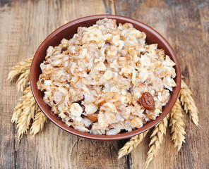 Porridge on wooden background.