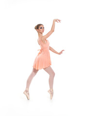 A young and beatiful female ballet dancer in a light dress