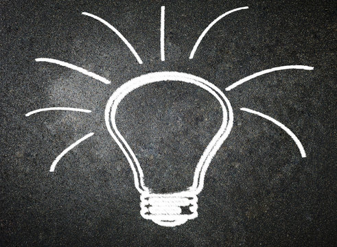 Light bulb on blackboard background
