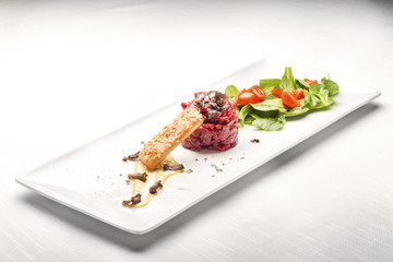Elegant Seasoned beef tartare with black truffles. Gourmet Delic