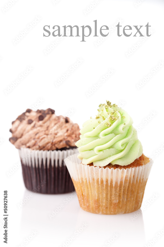 Wall mural two cupcakes with cream isolated on white background with copysp