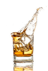 Whiskey glass with splash, isolated on white background