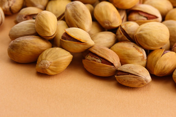 tasty pistachio nuts, on beige background