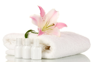 Obraz na płótnie Canvas beautiful lily with towel and bottles isolated on white