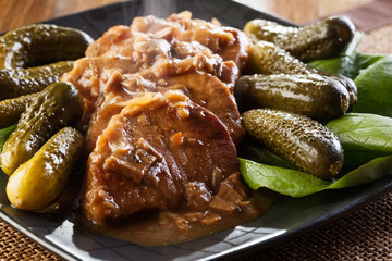 Pork loin with mushroom sauce. Dark light