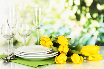 Yellow tulips and utensils for serving