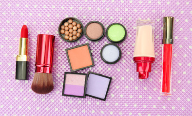 Decorative cosmetics on purple background