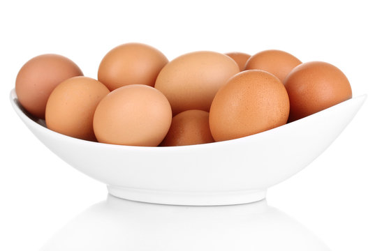 Eggs in white bowl isolated on white.