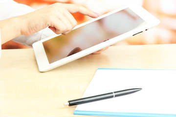 Female office worker using digital tablet in cafe