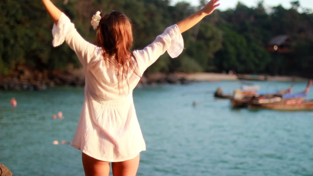 Girl at the resort in a dress on the background of the bays of