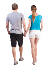 Back view of going young couple