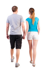 Back view of going young couple