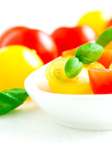 Assorted colorful red and yellow cherry tomatoes in plate close