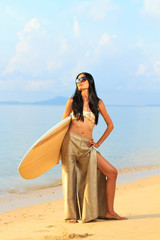 Portrait of an asian woman holding a surf board