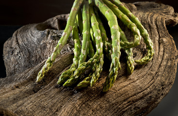 Bunch of fresh asparagus on a wooden table.