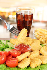 Fried chicken nuggets with vegetables,cola,french fries and