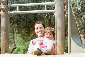 Fototapeta na wymiar happy mother with child at playground