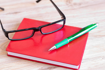 Business still life with diary and glasses