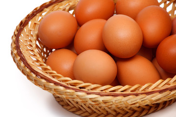 Colored eggs in straw plate