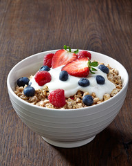 bowl of muesli and yogurt with fresh berries