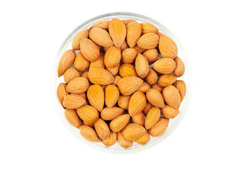Dried almonds on glass bowl isolated on a white background