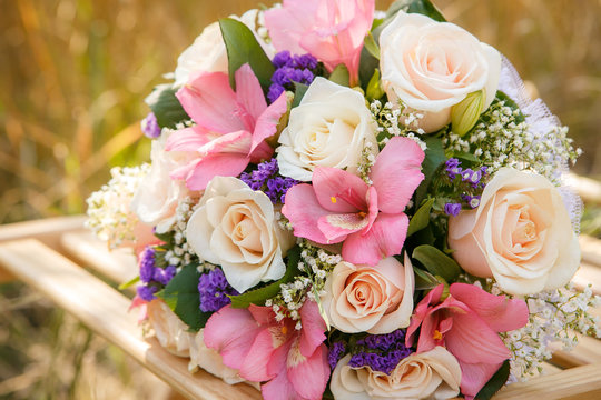 bouquet of the bride executed from light pink and beige roses