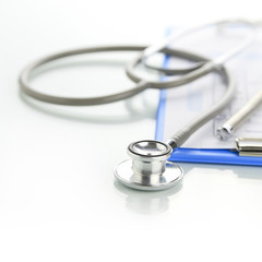 Stethoscope with blue medical clipboard