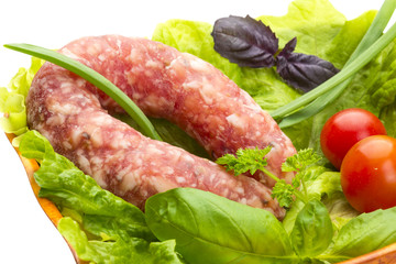 Ripe salami with salad, basil, onion and tomato
