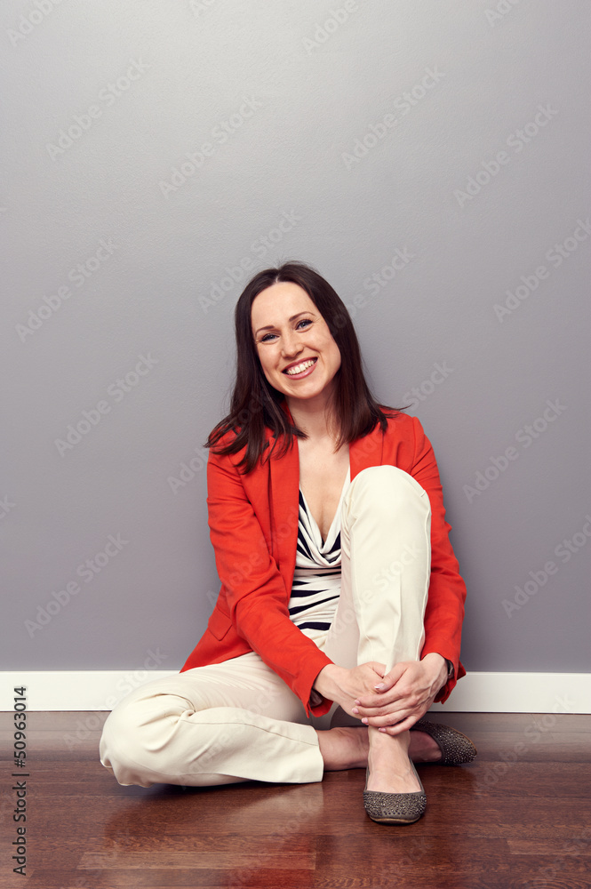 Wall mural young woman sitting on the floor