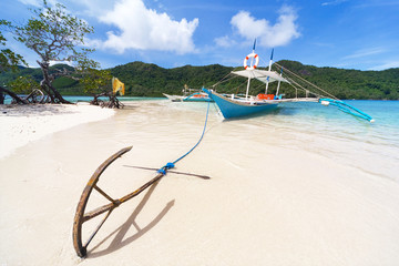 The boat with the anchor on the beach