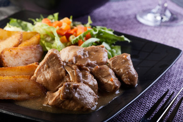 Goulash with prepared potatoes. Dark tone