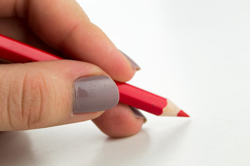 Left hand writing with red pencil