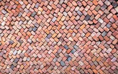Colorful wall of loosely piled bricks