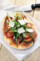 Food: Asparagus, rocket and cherry tomato pizza with Parmesan