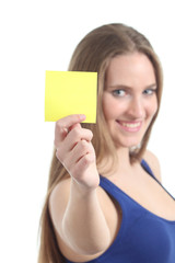 Woman holding and showing a blank yellow paper note