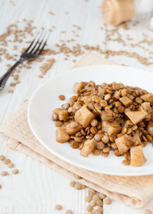 lentil stew with celery on a white plate