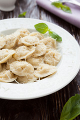 homemade ravioli with parmesan cheese in a white bowl