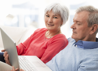 Close-up of a senior couple using laptop