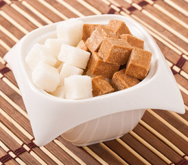 Close-up of cubes of brown and white sugar