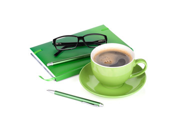 Green coffee cup, glasses and office supplies
