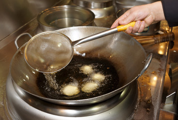 Doughnuts being ried in oil