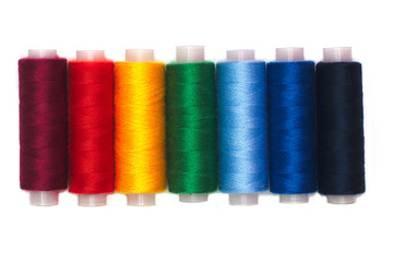 Rainbow colors thread spools isolated
