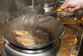 Prawns bein fried in wok pan