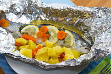 Trout fish with lemon slices and boiled potatoes