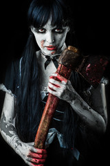 Dead female zombie with bloody axe